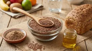 Ciotola di semi di lino con cucchiaio, pane integrale e olio su tavolo di legno